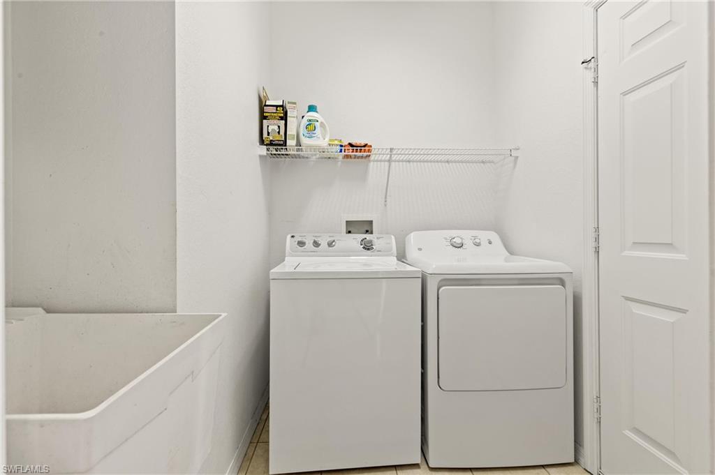 96 Glen Eagle Circle Naples, FL 34104 - Photo 18 of 33 a utility room with dryer and washer