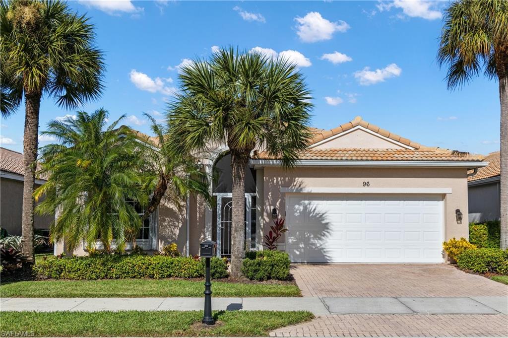 96 Glen Eagle Circle Naples, FL 34104 - Photo 2 of 33 a front view of house with yard and green space