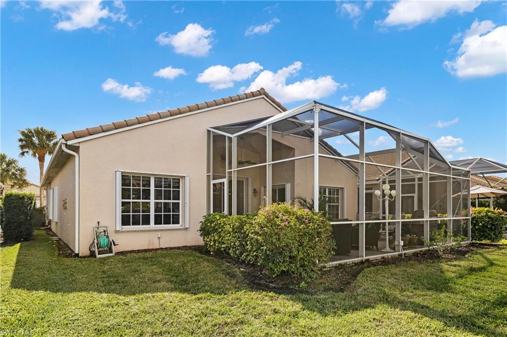 96 Glen Eagle Circle Naples, FL 34104 - Photo 23 of 33 a view of a backyard with plants and barbeque grill