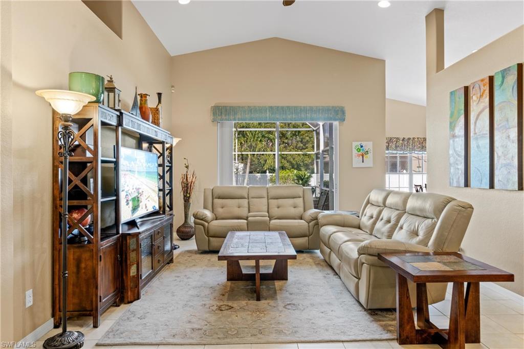 96 Glen Eagle Circle Naples, FL 34104 - Photo 4 of 33 a living room with furniture and a flat screen tv