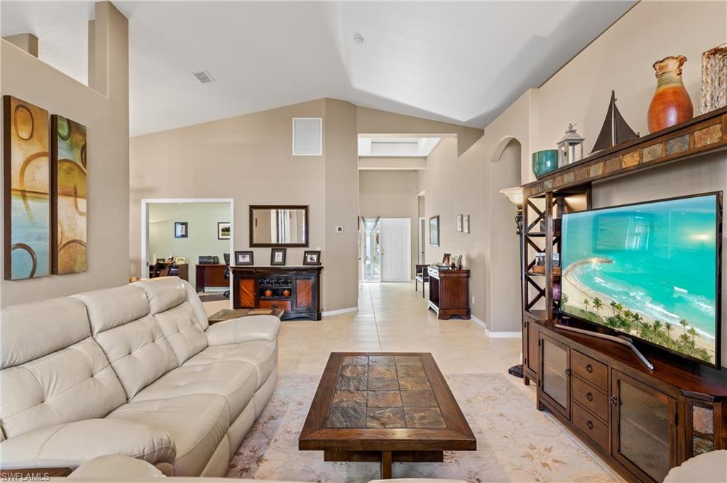 96 Glen Eagle Circle Naples, FL 34104 - Photo 5 of 33 a living room with furniture and a flat screen tv