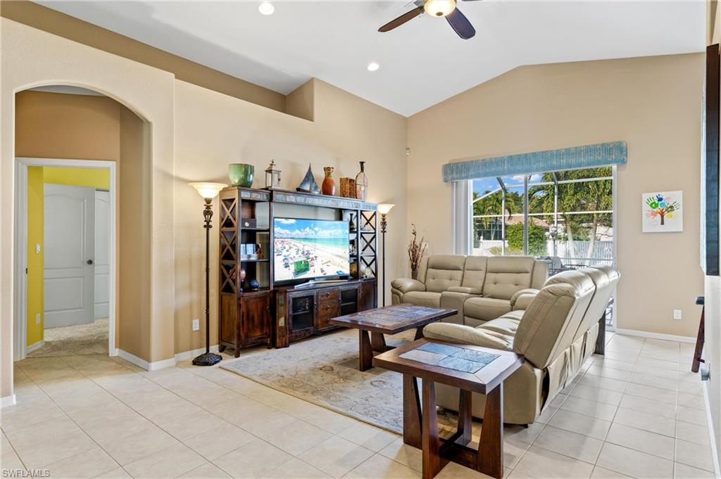 96 Glen Eagle Circle Naples, FL 34104 - Photo 6 of 33 a living room with furniture a window and a flat screen tv