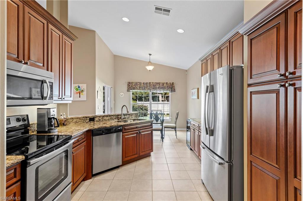 96 Glen Eagle Circle Naples, FL 34104 - Photo 7 of 33 a kitchen with stainless steel appliances granite countertop a refrigerator and a sink