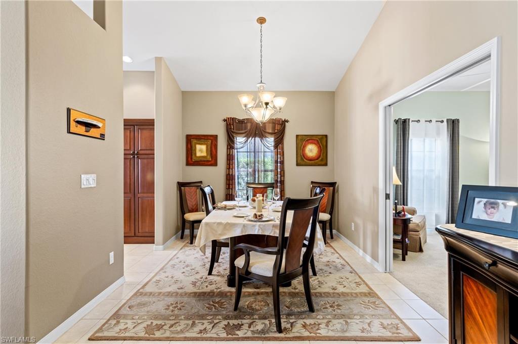 96 Glen Eagle Circle Naples, FL 34104 - Photo 10 of 33 a view of a dining room with furniture and chandelier
