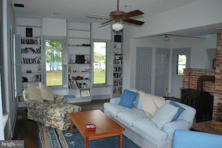 49588 Will's Road Dameron, MD 20628 - Photo 15 of 30 a living room with furniture fireplace and a chandelier