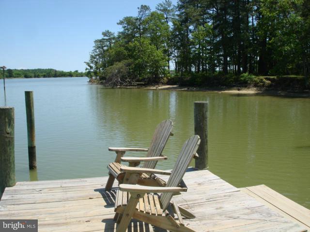 49588 Will's Road Dameron, MD 20628 - Photo 28 of 30 a view of a lake with a table and chairs