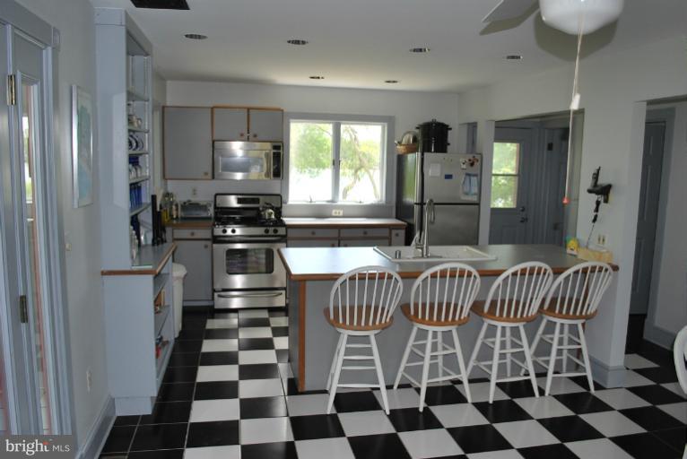 49588 Will's Road Dameron, MD 20628 - Photo 5 of 30 a kitchen with a sink and a black white checkered floor