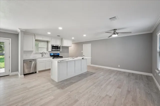 a kitchen with white cabinets and white appliances