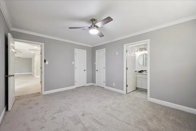 a view of an empty room and a ceiling fan