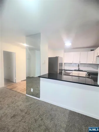a kitchen with stainless steel appliances a refrigerator and a stove top oven