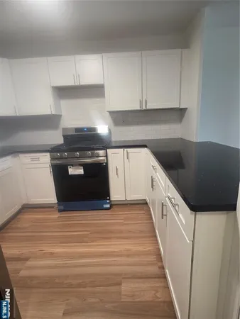 a kitchen with a sink and a stove top oven