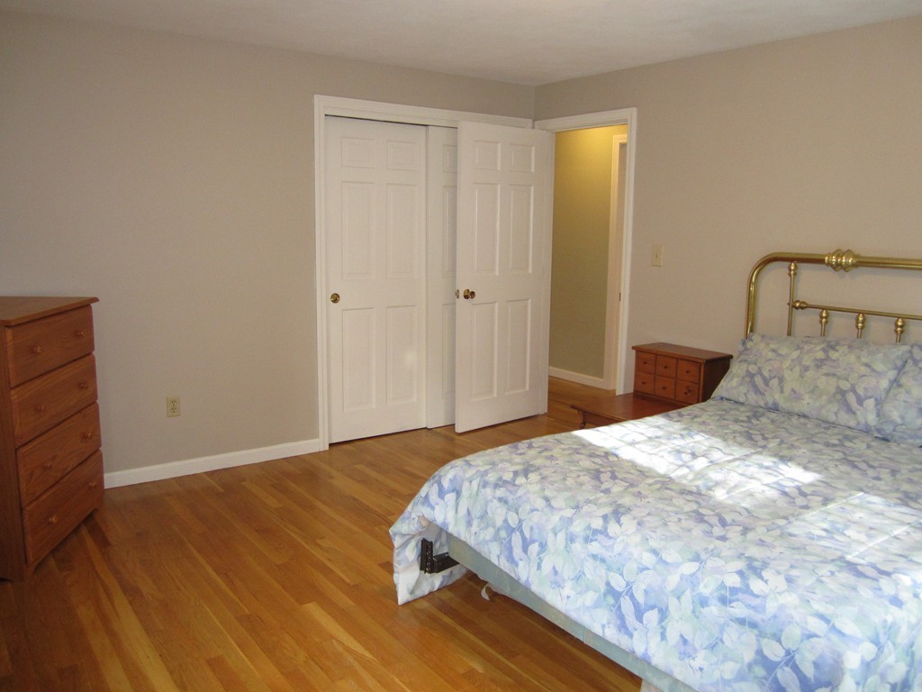27 Janes Road Boxford, MA 01921 - Photo 11 of 15 a bedroom with a bed and wooden floor