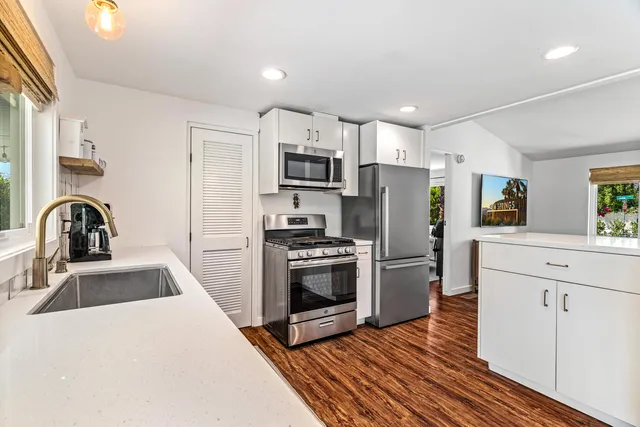 a view of a livingroom with furniture window and wooden floor