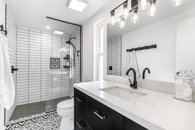 a view of a house with sitting area and view of lake