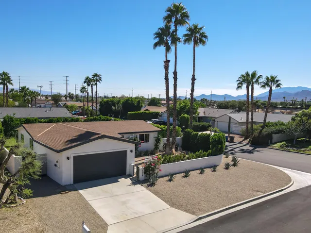 an aerial view of a house with a garden and mountain view