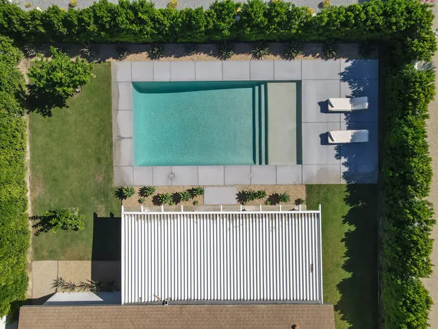 an aerial view of a house with garden space and street view