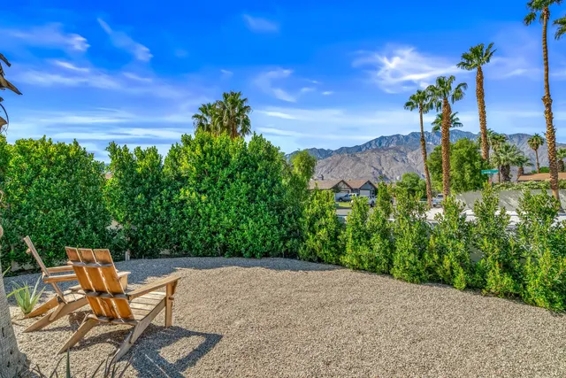 a backyard of a house with table and chairs