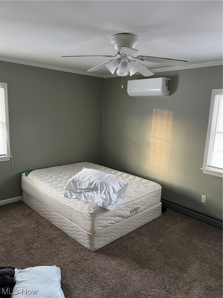 3215 Warren - Sharon Road Vienna, OH 44473 - Photo 14 of 25 Carpeted bedroom with an AC wall unit, ceiling fan, and crown molding