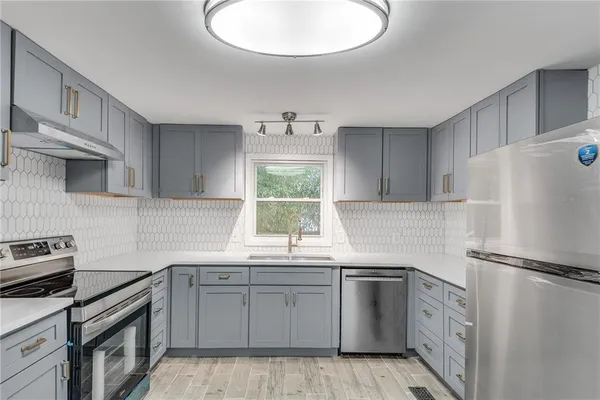 a kitchen with white cabinets and white appliances