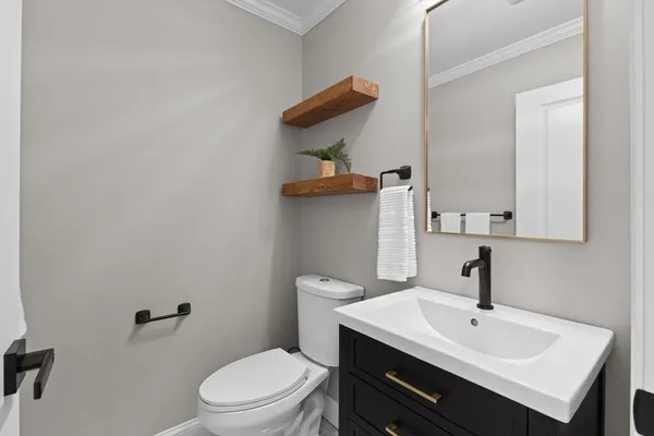 a bathroom with a sink a toilet and mirror