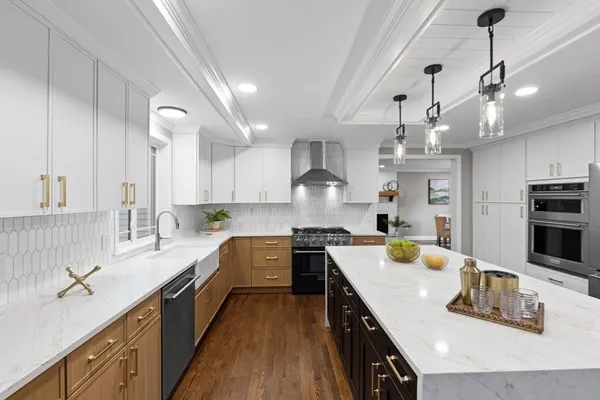 a open kitchen with kitchen island granite countertop a sink a counter space appliances and cabinets