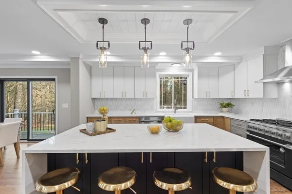 a kitchen with a table chairs and window
