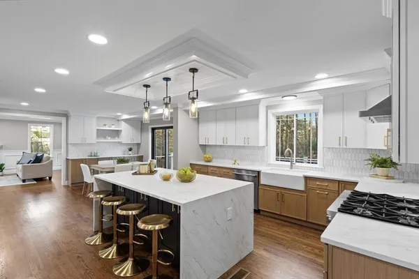 a kitchen with a table chairs stove and cabinets