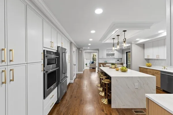 a kitchen with refrigerator cabinets and wooden floor