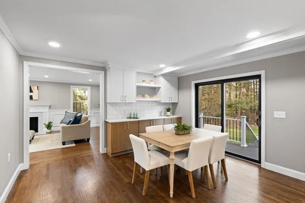 a dining room with furniture and wooden floor