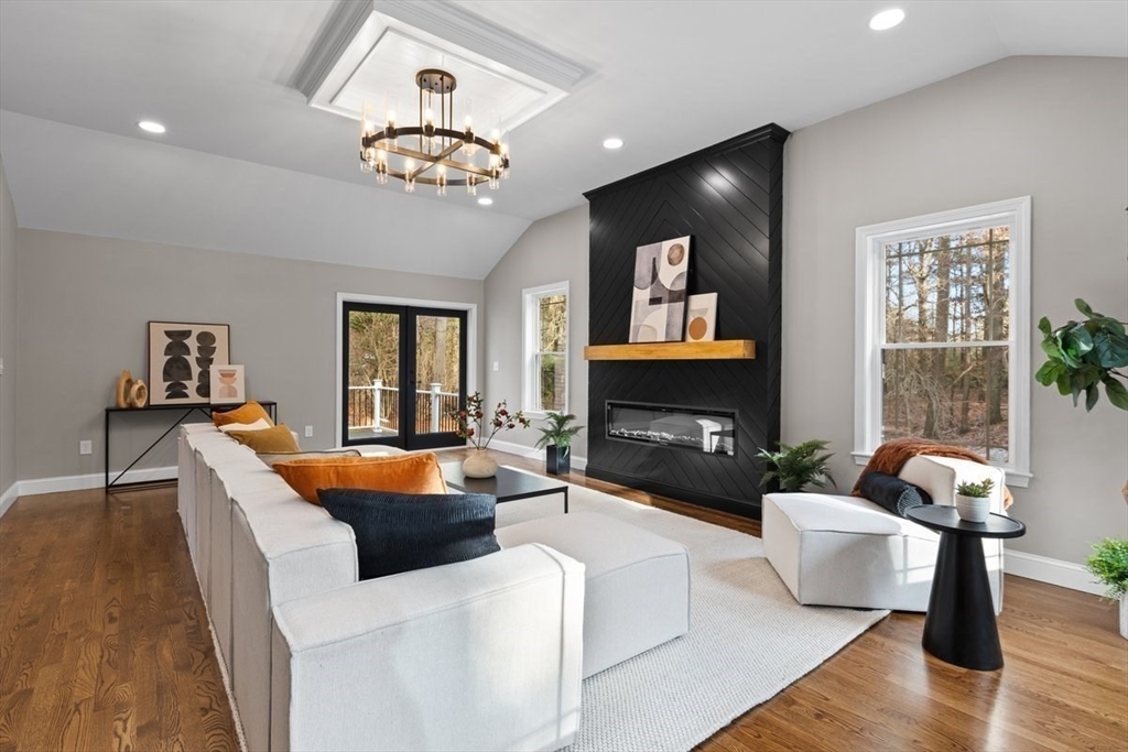 Lot 12 Brookside Lane Norfolk, MA 02056 - Photo 22 of 42 a living room with furniture a chandelier and a fireplace