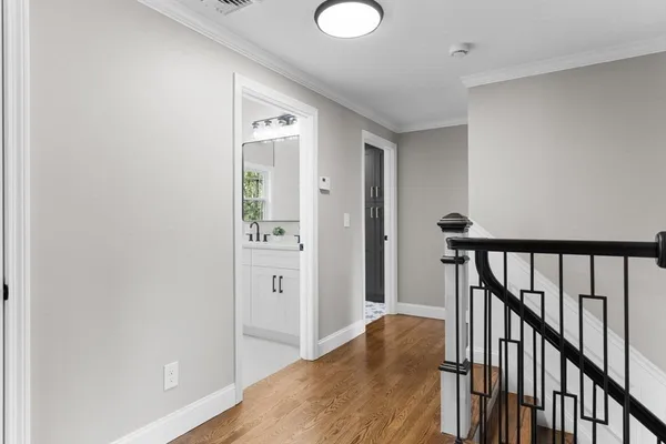 a view of a hallway with wooden floor and entryway