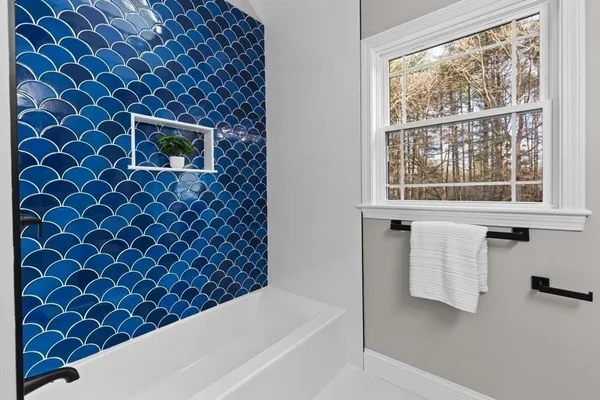 a bathroom with a sink a mirror and a bathtub