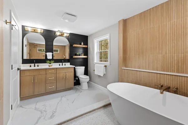 a bathroom with a sink a toilet and mirror