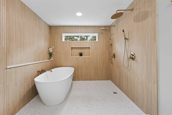a bathroom with a white bath tub and shower