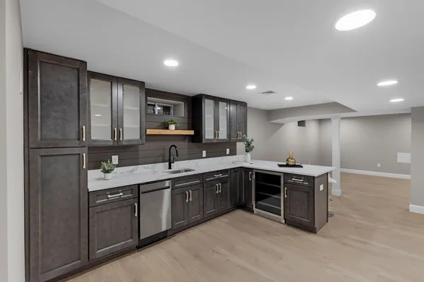 a large kitchen with cabinets and stainless steel appliances