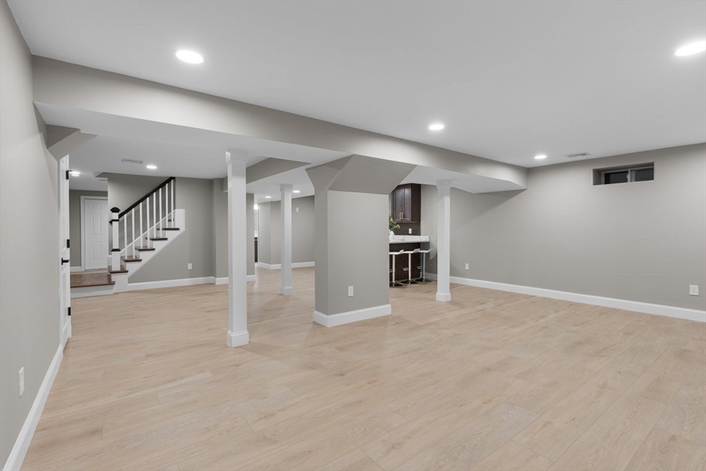 Lot 12 Brookside Lane Norfolk, MA 02056 - Photo 36 of 42 an empty room with wooden cabinet and windows