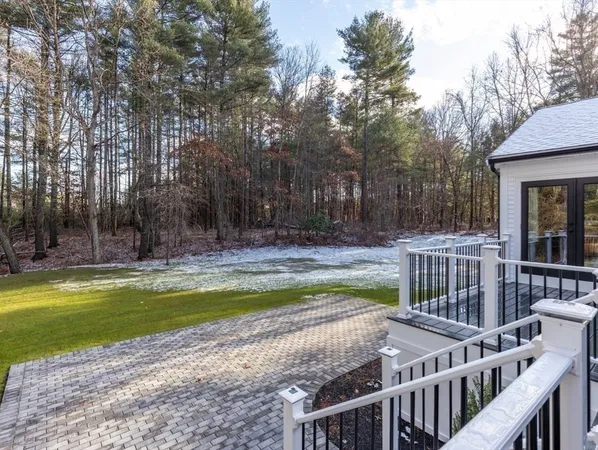 a view of a swimming pool with a deck and wooden fence