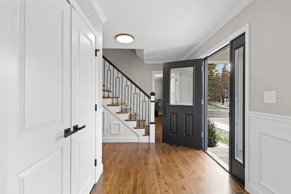 a view of entryway with wooden floor and stairs