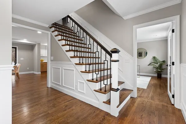 a view of entryway and hall with wooden floor