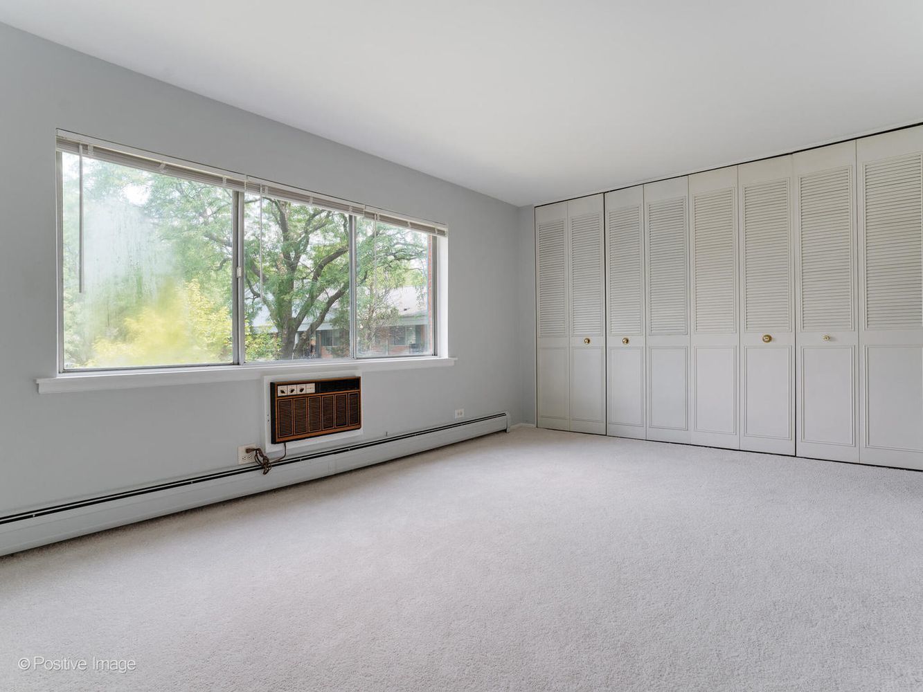 2407 South Goebbert Road, Unit 201 Arlington Heights, IL 60005 - Photo 12 of 22 a view of an empty room with a window
