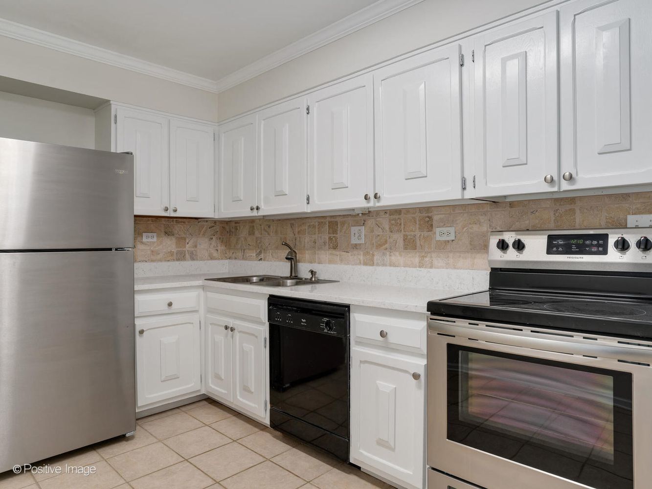 2407 South Goebbert Road, Unit 201 Arlington Heights, IL 60005 - Photo 9 of 22 a kitchen with white cabinets and white appliances