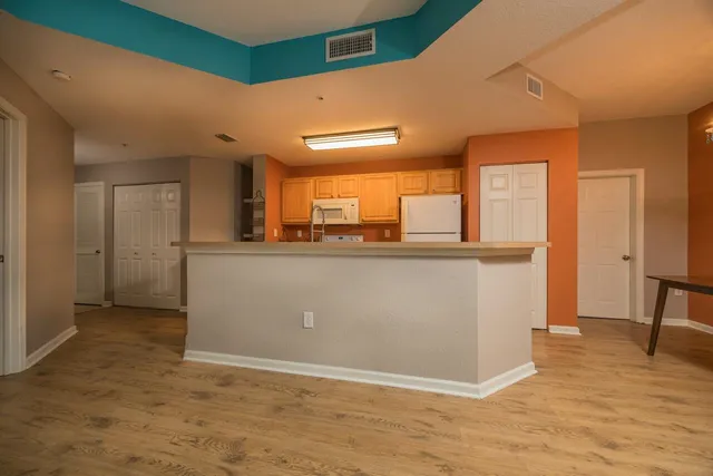 a view of a kitchen with kitchen island a sink a counter space and a window