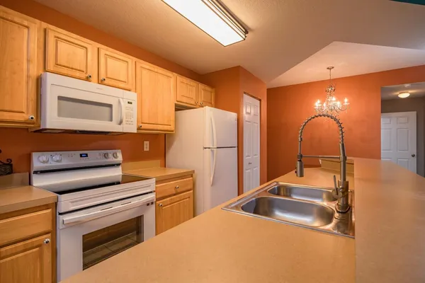 a kitchen that has a stove and a refrigerator