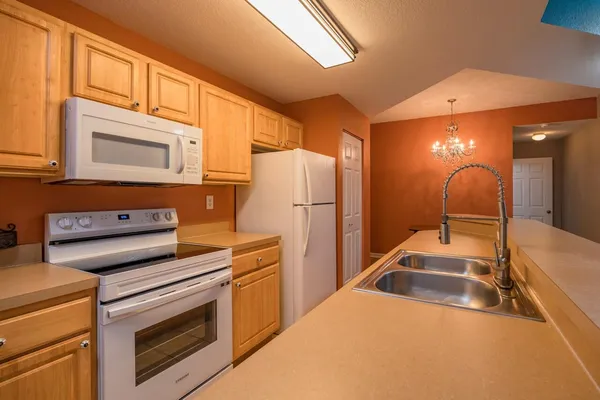a kitchen with granite countertop a sink and cabinets
