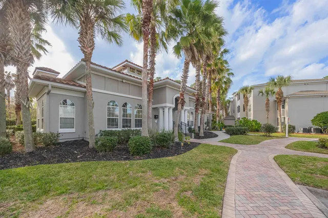 a view of a house with a garden and swimming pool