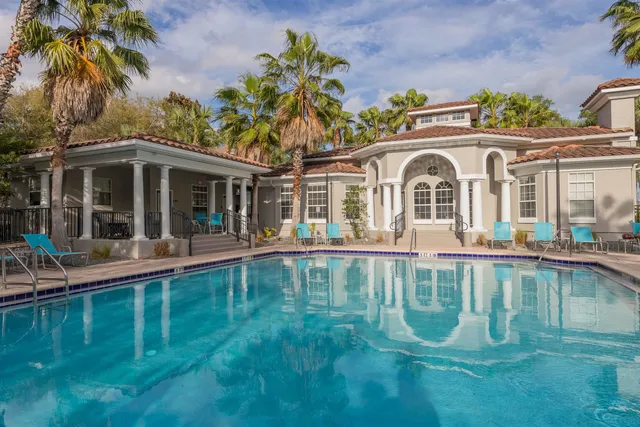 a view of a house with backyard porch and sitting area
