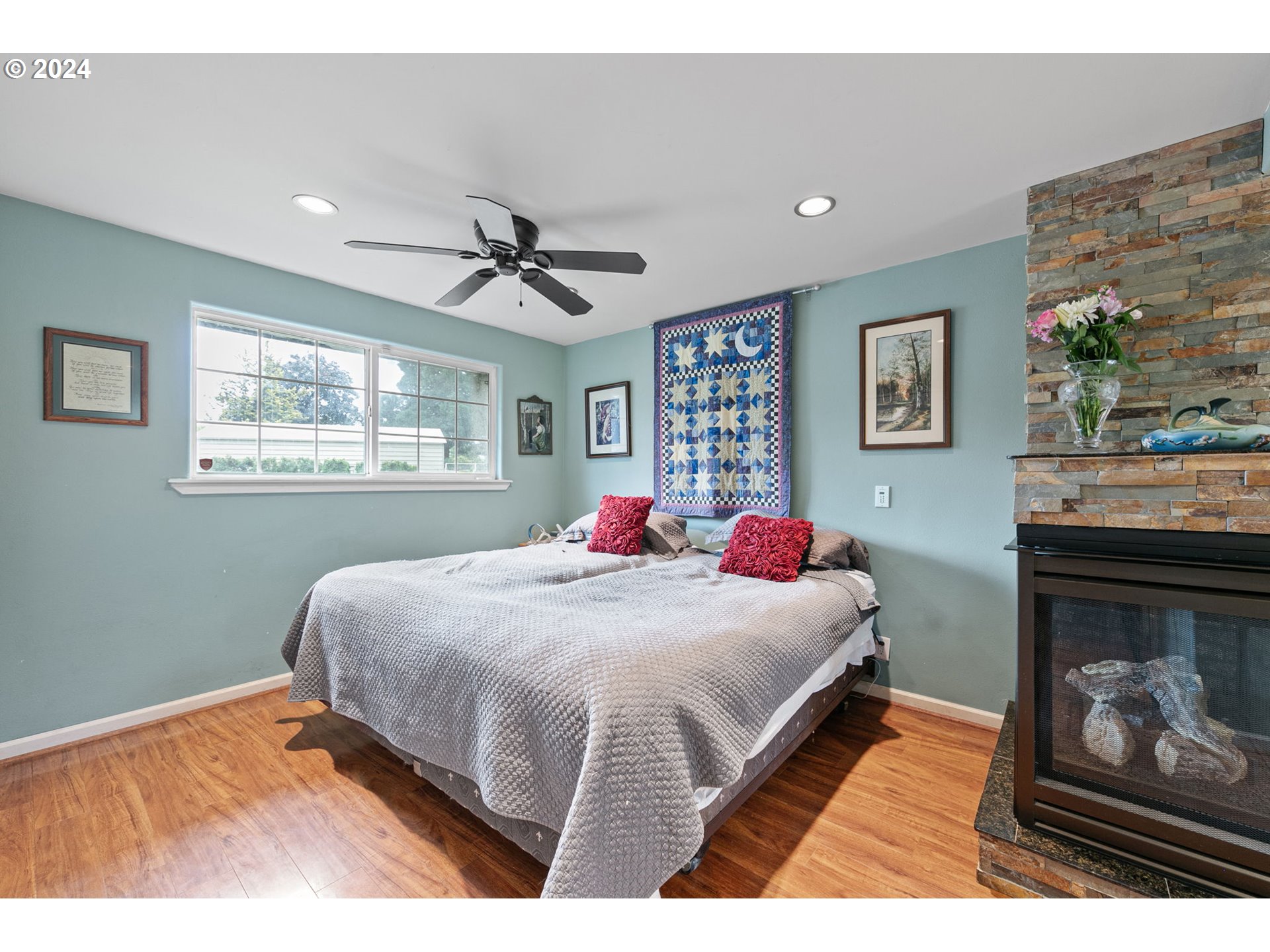 2990 Hyacinth Street Eugene, OR 97404 - Photo 11 of 47 a bedroom with a large bed and a chandelier