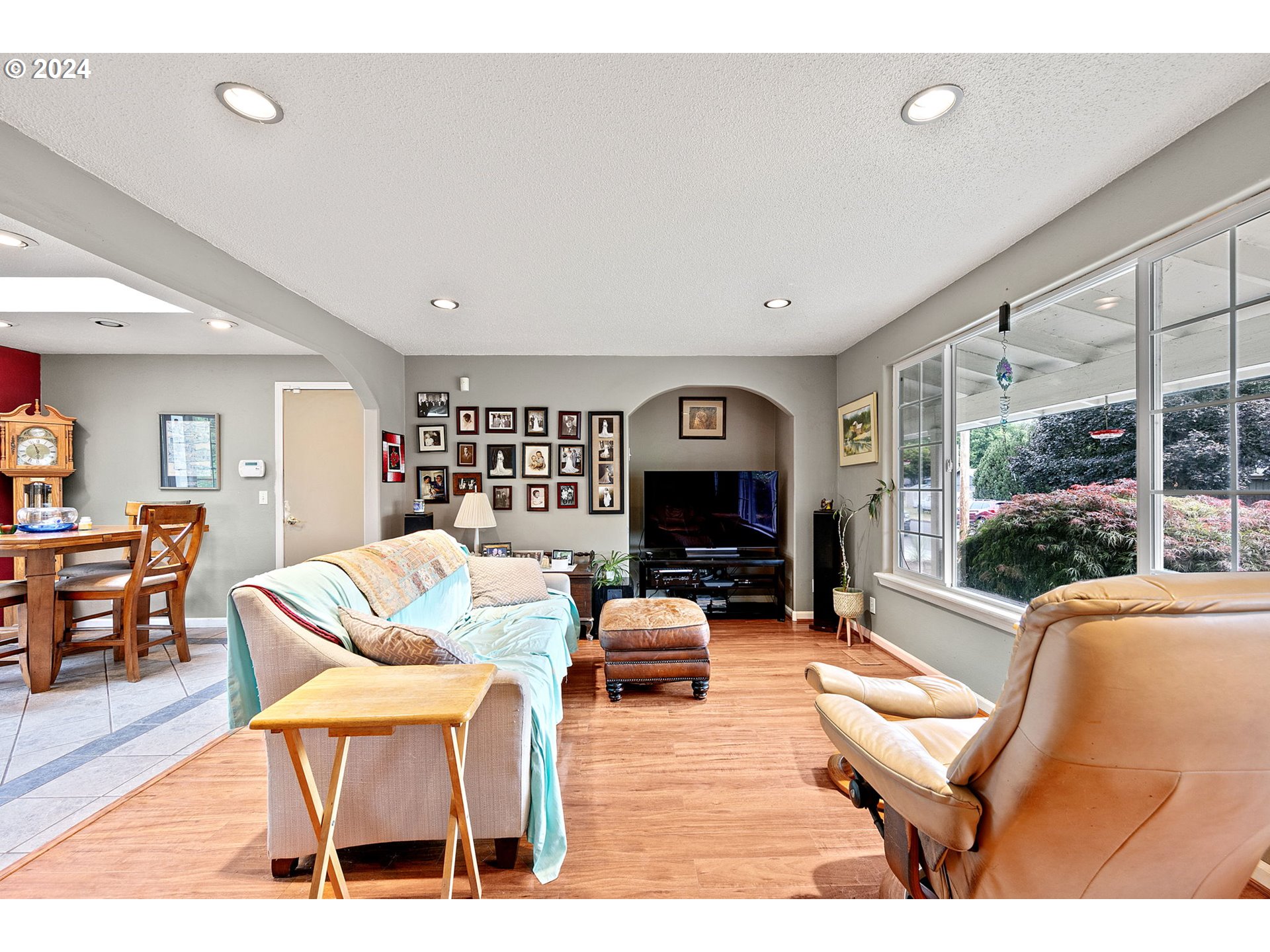 2990 Hyacinth Street Eugene, OR 97404 - Photo 10 of 47 a living room with furniture a fireplace and a floor to ceiling window