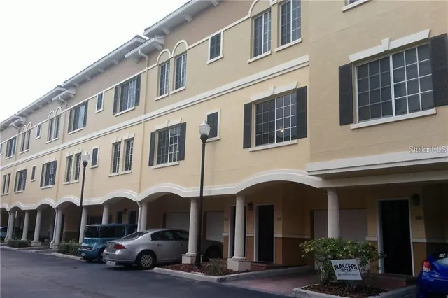 a couple of cars parked in front of a building