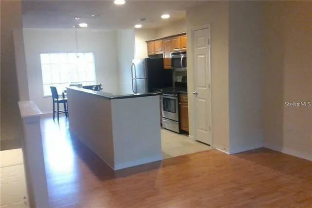 a kitchen with stainless steel appliances a refrigerator and a microwave